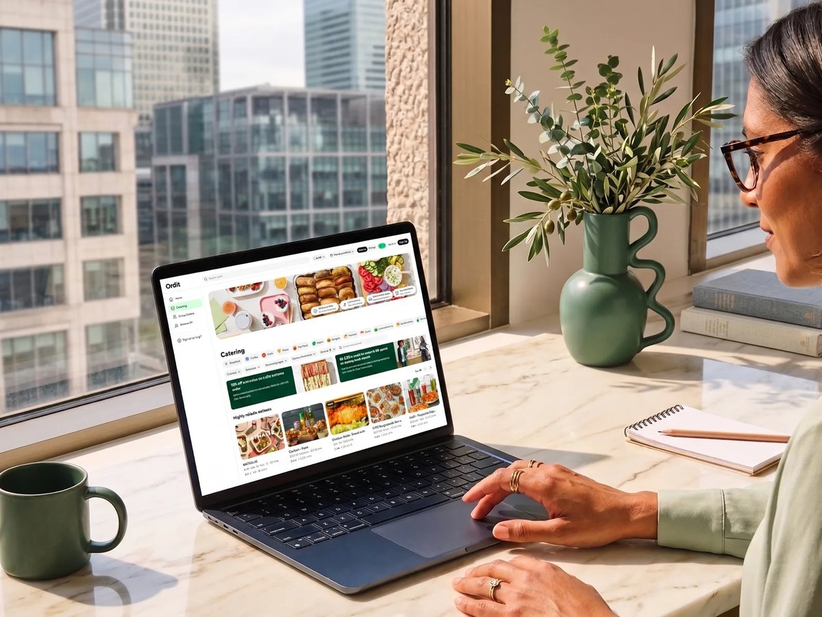An office manager browsing Ordit catering on a laptop