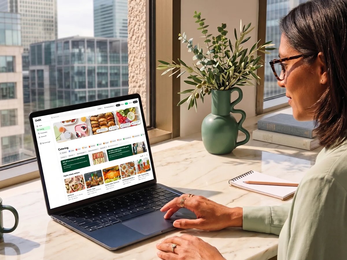 An office manager browsing Ordit catering on a laptop